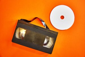 video tape adn DVD on oragen background